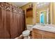 Compact bathroom featuring a shower, toilet, and vanity with cabinet storage at 4450 Millenium View Ct, Snellville, GA 30039