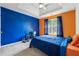 Bedroom with vaulted ceilings, large window, blue accent wall, and comfortable bed at 4450 Millenium View Ct, Snellville, GA 30039