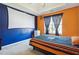 Bedroom with blue and orange walls and a projector at 4450 Millenium View Ct, Snellville, GA 30039