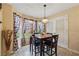 Bright breakfast nook with a square table, four chairs, and large windows with patterned curtains at 4450 Millenium View Ct, Snellville, GA 30039