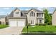 Charming two-story home featuring a two-car garage, a well-manicured lawn, and classic architectural details at 4450 Millenium View Ct, Snellville, GA 30039