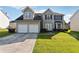Two-story house with a two-car garage and a well-maintained lawn at 4450 Millenium View Ct, Snellville, GA 30039