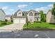 Charming two-story home featuring a manicured lawn, two-car garage, and inviting front entrance at 4450 Millenium View Ct, Snellville, GA 30039