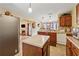 Spacious kitchen with an island, stainless steel refrigerator, and view to the living room at 4450 Millenium View Ct, Snellville, GA 30039