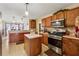 Functional kitchen featuring wood cabinetry, modern appliances, and an open layout at 4450 Millenium View Ct, Snellville, GA 30039
