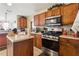 Kitchen with wood cabinets, stainless steel appliances, and an island at 4450 Millenium View Ct, Snellville, GA 30039