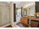 Bright main bathroom includes a shower, tub, single sink vanity, and a window at 4450 Millenium View Ct, Snellville, GA 30039