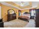 Comfortable main bedroom features a tray ceiling, large bed, and ample closet space at 4450 Millenium View Ct, Snellville, GA 30039