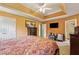 Bright main bedroom featuring a tray ceiling, carpeted floors, and plenty of natural light at 4450 Millenium View Ct, Snellville, GA 30039
