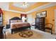 Main bedroom with king-size bed and orange walls at 4450 Millenium View Ct, Snellville, GA 30039