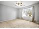 Bright bedroom with large window and ceiling fan at 5480 Sable Bay Pt, Atlanta, GA 30349