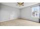 Well-lit bedroom with window, ceiling fan and access to attic at 5480 Sable Bay Pt, Atlanta, GA 30349