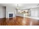 Open living room features hardwood floors, a fireplace, and an adjacent kitchen at 5480 Sable Bay Pt, Atlanta, GA 30349