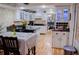 Bright eat-in kitchen with white cabinets, stainless steel appliances, and hardwood floors at 1400 New Hope Church Rd, Loganville, GA 30052