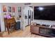 Cozy living room featuring a large TV and a view into the kitchen at 1400 New Hope Church Rd, Loganville, GA 30052