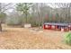 Backyard with firepit and red shed at 1400 New Hope Church Rd, Loganville, GA 30052