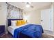 Bedroom with a queen bed, yellow pillows and a ceiling fan at 2082 Perkerson Sw Rd, Atlanta, GA 30310