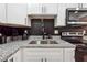 Modern kitchen features granite countertops and a hexagon backsplash at 2082 Perkerson Sw Rd, Atlanta, GA 30310