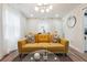 Living room with mustard sofa, coffee table, and natural light at 2082 Perkerson Sw Rd, Atlanta, GA 30310