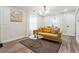 Cozy living room with a mustard yellow couch and wood floors at 2082 Perkerson Sw Rd, Atlanta, GA 30310