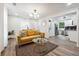 Bright and airy living room with a mustard yellow couch and a view to the kitchen at 2082 Perkerson Sw Rd, Atlanta, GA 30310