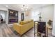 Bright living room with mustard sofa, fireplace, and kitchen view at 2082 Perkerson Sw Rd, Atlanta, GA 30310