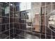 Modern shower with dark tile and glass enclosure at 2082 Perkerson Sw Rd, Atlanta, GA 30310