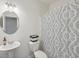Small bathroom with toilet, sink, and patterned shower curtain at 5534 Radford Loop, Fairburn, GA 30213