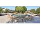 Circular stone fountain in a community courtyard with benches and landscaping at 5534 Radford Loop, Fairburn, GA 30213