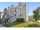 Modern three-story townhome with gray siding and stone accents at 5534 Radford Loop, Fairburn, GA 30213