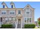 Stylish townhome boasts gray siding, stone accents, and a charming front entrance at 5534 Radford Loop, Fairburn, GA 30213