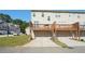 Exterior view of townhomes highlights private garages and deck areas at 5534 Radford Loop, Fairburn, GA 30213