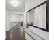 The upstairs hallway offers lots of natural light and beautiful hardwood flooring at 5534 Radford Loop, Fairburn, GA 30213