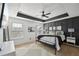 Stylish main bedroom with tray ceiling, modern decor, and plenty of natural light at 5534 Radford Loop, Fairburn, GA 30213