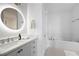 Modern bathroom with a vanity, large mirror, and a bathtub at 116 Bridle Ridge Ln, Canton, GA 30114