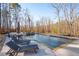 Relaxing pool area with lounge chairs, umbrellas, and wooded backdrop at 116 Bridle Ridge Ln, Canton, GA 30114