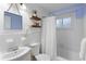 Clean bathroom with white tile and a tub shower combo at 2186 Dering Ne Cir, Atlanta, GA 30345