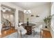 Dining area features hardwood floors, white wainscoting, a modern chandelier, and bright natural light at 5016 Whiteoak Se Pointe, Smyrna, GA 30080