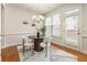 Bright dining area with hardwood floors, a modern chandelier, and a walk-out patio door at 5016 Whiteoak Se Pointe, Smyrna, GA 30080