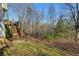 Stairs leading down to a grassy backyard with wooded backdrop at 674 Fairview Dr, Dallas, GA 30157