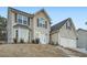 Two-story house with a two-car garage and light beige vinyl siding at 851 Louisa Ln, Lithonia, GA 30058