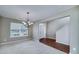 Bright dining area with carpeted floors, a chandelier, and access to other rooms at 8256 Milam Loop, Fairburn, GA 30213