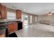 Kitchen features dark countertops and appliances, wood cabinets, and sliding glass doors to backyard at 8256 Milam Loop, Fairburn, GA 30213