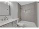 Updated bathroom with tub and shower, gray tile, and new vanity at 1412 Tuxworth Cir, Decatur, GA 30033