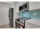 Updated kitchen featuring stainless steel appliances and white shaker cabinets at 1412 Tuxworth Cir, Decatur, GA 30033