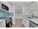 Modern kitchen with stainless steel appliances and light blue tile backsplash at 1412 Tuxworth Cir, Decatur, GA 30033