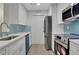 Renovated kitchen with stainless steel appliances and blue accents at 1412 Tuxworth Cir, Decatur, GA 30033