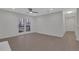 Open living room with hardwood floors, ceiling fan and access to hallway at 1412 Tuxworth Cir, Decatur, GA 30033