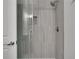 Updated shower with gray tile and glass enclosure at 1412 Tuxworth Cir, Decatur, GA 30033