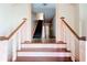 Inviting foyer featuring a staircase with a wooden banister and neutral walls at 2812 Highway 16 E, Sharpsburg, GA 30277